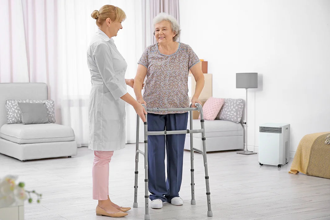 nurse with elderly woman near inova air purifier