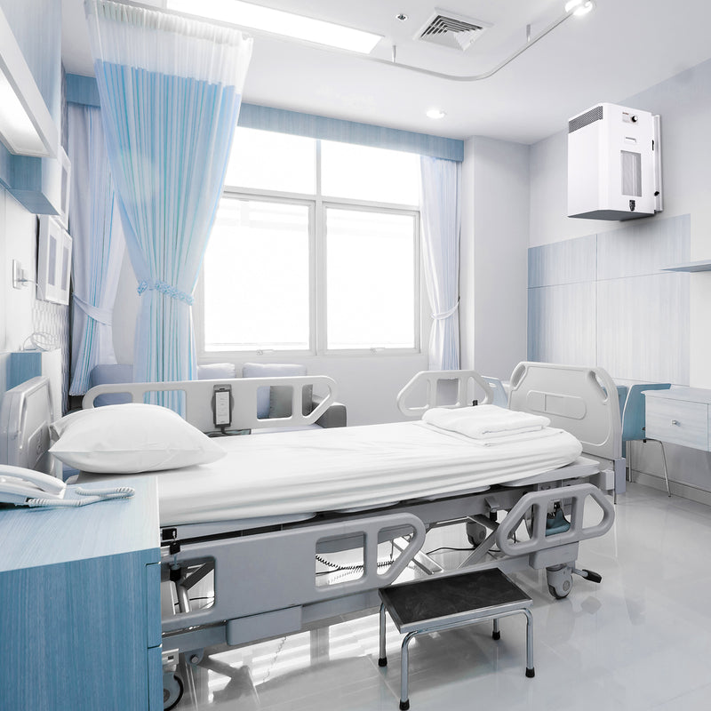 Load image into Gallery viewer, A typical hospital ward with a single, unoccupied bed. An INOVA air purifier is mounted on a wall, quietly removing viruses from the air with its H13 medical-grade HEPA filter.