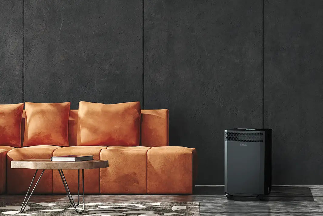 inova air purifier near orange couch